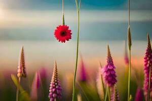 a red flower is hanging from a string in front of a field. AI-Generated photo