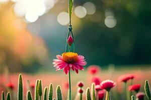 a pink flower is hanging from a vine in a field. AI-Generated photo