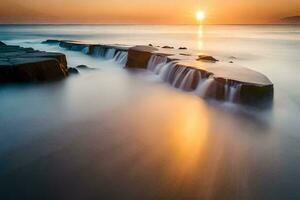 the sun sets over a rocky beach with water flowing over it. AI-Generated photo