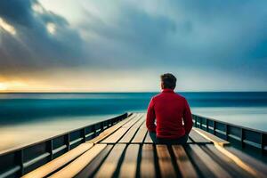 a man sitting on a pier looking out at the ocean. AI-Generated photo