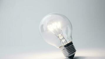 Glowing glass light bulb on grey background photo