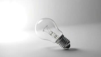 Glowing glass light bulb on grey background photo