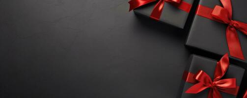 Gift box with red ribbon on black background. Top view with copy space photo