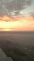 aerial view of a river and fields at sunrise video