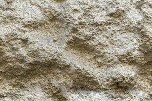 Seamless beige rock stone wall background texture photo