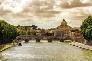 Tiber river, Ponte Sant'Angelo and St. Peter's cathedral, Roma, Italy photo