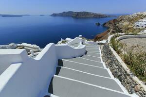 Stairs and volcano at Oia island, Greece photo