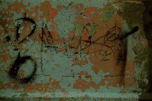 Old dilapidated wall texture with graffiti photo