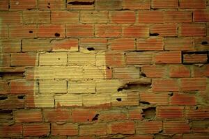 Old damaged wall texture with striated red bricks photo