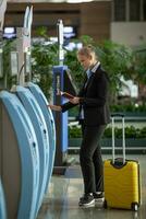 Easy and quick check-in with self-service terminals at the airport photo