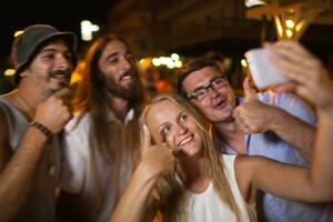 Happy selfie of friends at night photo