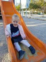 Little girl enjoying time on playground photo