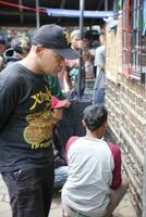 Magelang Indonesia, Feb 10-10-2023. Indonesian men looking birds in cage. Browse transactions in birds market. photo