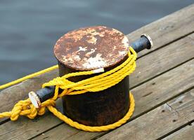 Rusty bollard by water photo