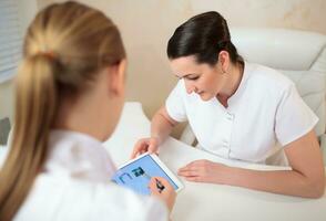 Two cosmeticians having talk on business photo