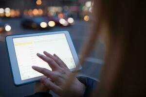 Woman touching tablet screen photo