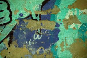 Dilapidated wall background texture with graffiti photo