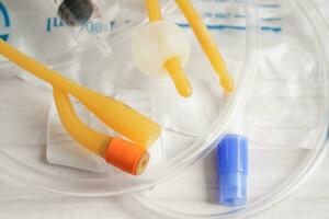 Foley catheter and urine drainage bag collect urine for disability or patient in hospital. photo