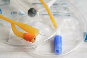 Foley catheter and urine drainage bag collect urine for disability or patient in hospital. photo