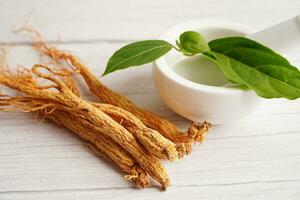 Ginseng roots and green leaf, healthy food. photo