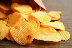 Potato chips in open bag, delicious BBQ seasoning spicy for crips, thin slice deep fried snack fast food. photo