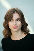 Close up portrait of a beautiful young woman smiling and looking at camera. White European girl with beautiful smile photo