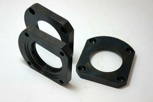Black steel face flange part manufacturing with CNC machine. photo