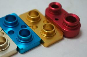 a batch of anodize aluminum cnc parts production. close-up. photo