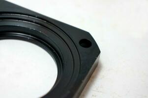 Black steel face flange part manufacturing with CNC machine. photo