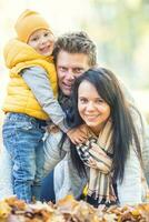 Boy mom father happy family in autumn park. photo