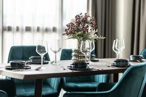 Dining room with wooden table and blue chairs floor in modern apartment photo