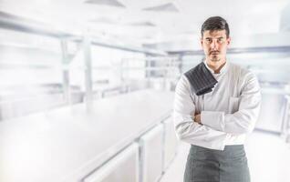 Chef professional in restaurant kitchen standing with crossed hands photo