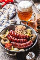 Roasted sausages with vegetable and draft beer. photo