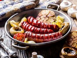 Roasted sausages with vegetable and draft beer. photo