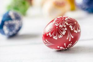 Close-up multicolored easter eggs on wooden table photo