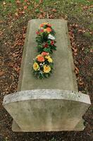Tombstone covered with flowers photo