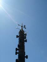 Weather vane and blue sky photo