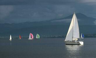 Sailing boats by stormy weather, Geneva lake, Switzerland photo