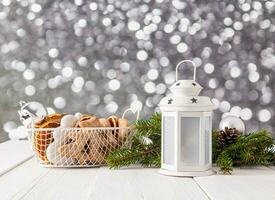 Beautiful New Year and Christmas composition with a white lantern, a basket with glazed gingerbread and dried orange slices. spruce branches. , bokeh photo