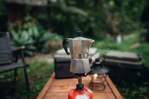 Moka pot coffee on outdoor camping table photo