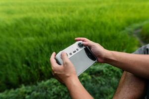 Drone remote control in hand, piloting the drone photo