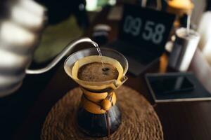 Drip coffee,Pouring water into filter coffee maker photo