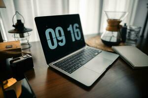 Home computer desk and digital clock on screen photo