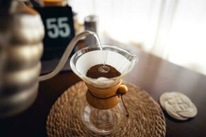 Drip coffee,Pouring water into filter coffee maker photo