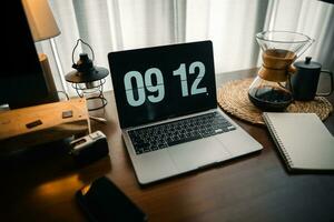 Home computer desk and digital clock on screen photo