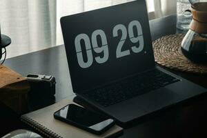 Home computer desk and digital clock on screen photo