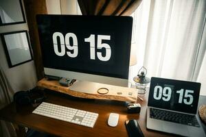 Home computer desk and digital clock on screen photo