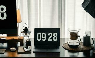 Home computer desk and digital clock on screen photo