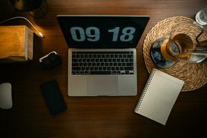 Home computer desk and digital clock on screen photo