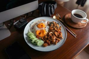 Fried eggs and stir-fried chicken with basil photo